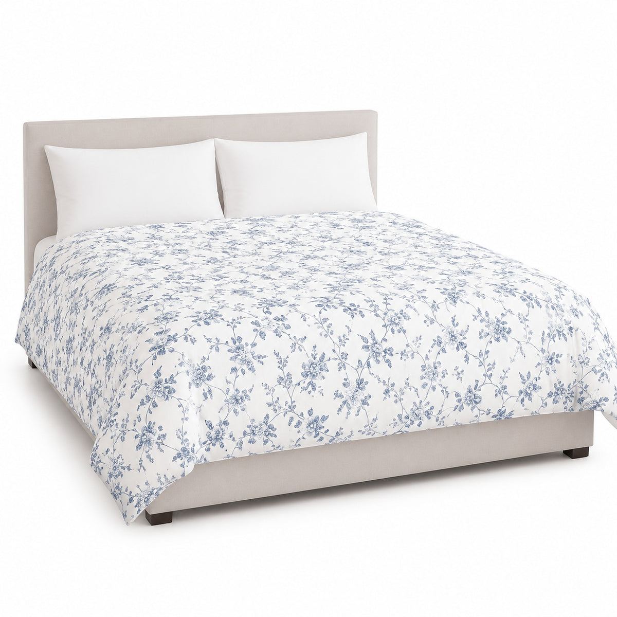 Primeval white dusty blue floral vine duvet cover displayed on a styled bed against a clean white studio background