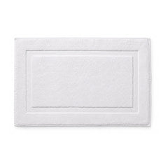 White hotel style bath mat with framed border on white background