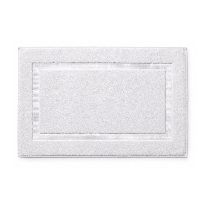 White hotel style bath mat with framed border on white background
