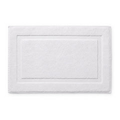 White hotel style bath mat with framed border on white background