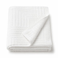 White raised geometric tufted cotton bath towel 70x140 cm on white background