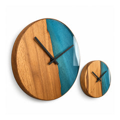 Two round wooden wall clocks in different sizes with teal-blue resin-look sections and minimal black clock hands