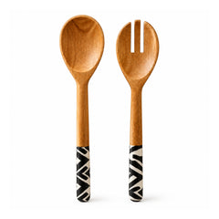 Wooden salad serving spoon and two-prong serving fork with long handles decorated in bold black-and-white geometric patterns