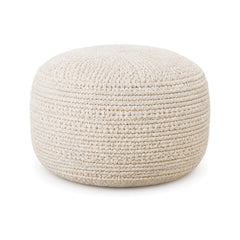 Solid ivory chunky knitted round pouf ottoman on white background